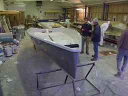 Simon Hipkin and Andy Ladds of BlueMotion Yachts Ltd inspect the first boat off the mould at White Formula, Brightlingsea, Essex, 7 January 2014 